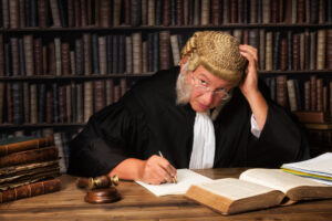 Mature judge with authentic court wig and gavel in court